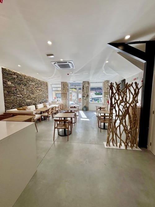 Lounge Casa Tawny com paredes de pedra, divisória de ramo de madeira e mobiliário moderno em Pinhão