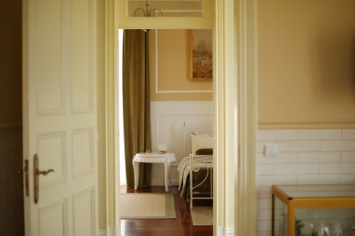 Elegant hallway view into bedroom at Villa Várzea boutique guesthouse in Várzea, Portugal