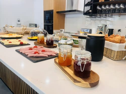 Casa Tawny breakfast spread in Pinhão with charcuterie, pastries, jams, and fresh fruits on kitchen counter