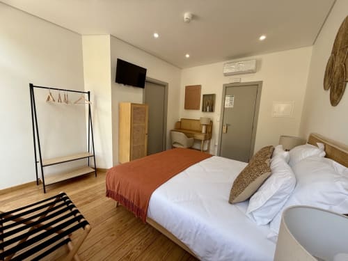 Tinta Barroca double room at Casa Tawny in Pinhão with modern bed, wooden furnishings, and mountain views
