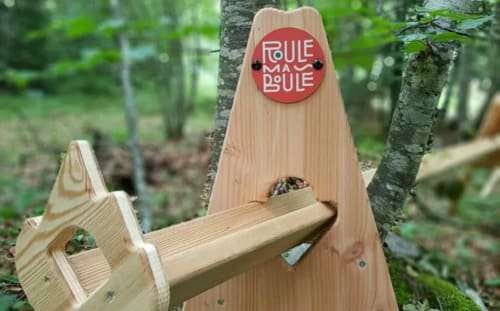 Wooden birdhouse with red 'Boule à Boule' sign at Maison de Sophie B&B in Rencurel, France forest setting