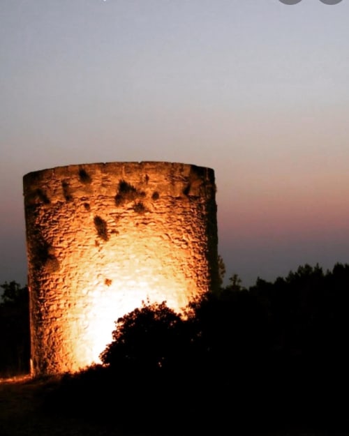 Beleuchteter Steinturm in der Abenddämmerung mit Waldkulisse, Gartenblick der Villa La Conciergerie De Franck in Boissieres