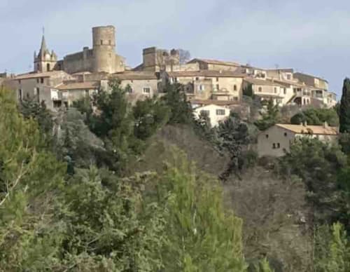 Village médiéval perché de Boissieres avec bâtiments en pierre et clocher église entourés de cyprès