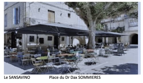 Le Sansavino outdoor café terrace with black awning, tables, and seating at Place du Dr Dax Sommieres, Boissieres