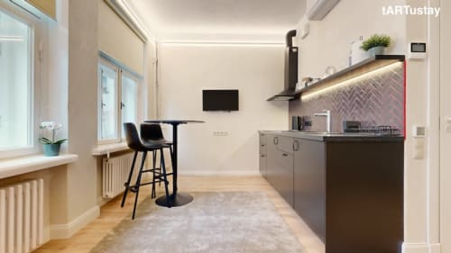 Fully equipped modern kitchen with all cooking essentials. Ralf Sannikov studio in Tartu center near Raekoja Square. RIMI grocery & MyFitness next door