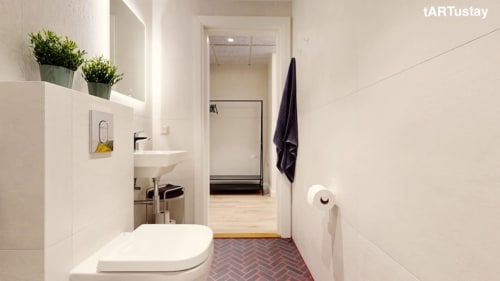 Bright bathroom with herringbone floor in Ralf Sannikov's studio. Modern amenities in Tartu center, close to Raekoja Square, RIMI & MyFitness