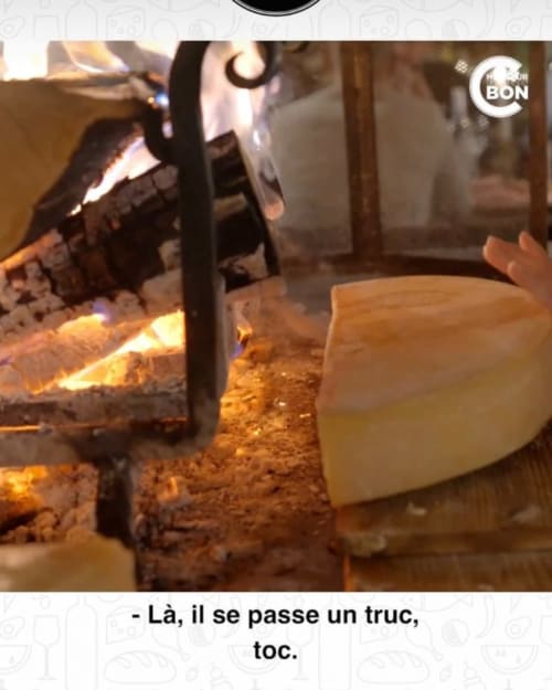Fireplace with glowing logs and stone hearth at Auberge Nemoz, Le Haut-Bréda