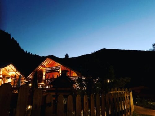 Auberge Nemoz lit up at dusk, cozy French B&B nestled in Le Haut-Bréda mountains at twilight