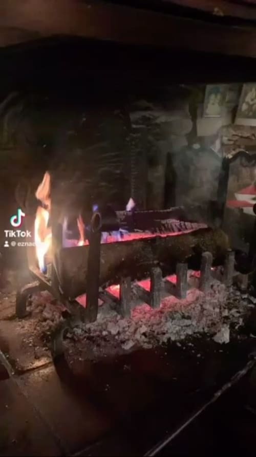 Glowing firepit at Auberge Nemoz, a French bed and breakfast in Le Haut-Bréda, with warm evening ambiance