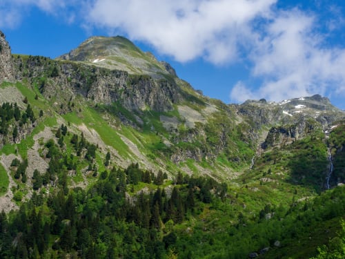 Alpine mountain landscape with forested slopes and rocky peaks near Auberge Nemoz, Le Haut-Bréda France