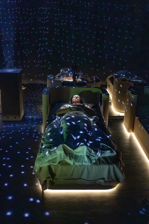 Guest sleeping in bed with starry projection at Maison de Sophie, cozy BnB in Rencurel, France
