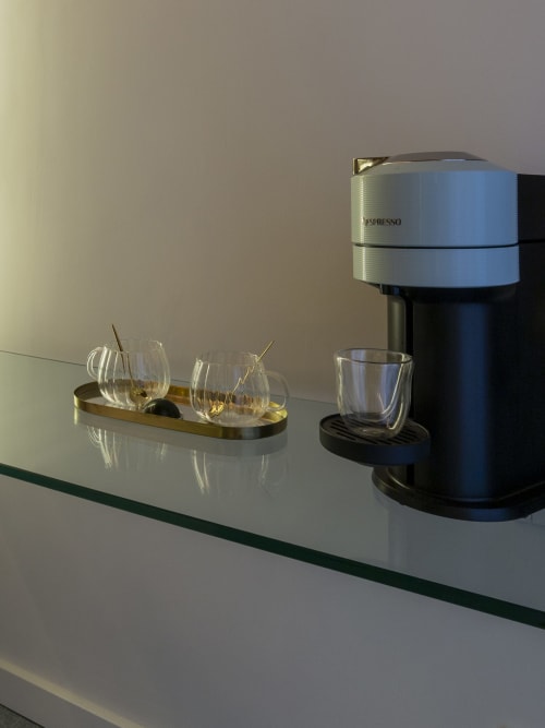 Macchina Nespresso con tazzine di espresso su tavolo in vetro presso YOUnique Boutique Rooms, Milano