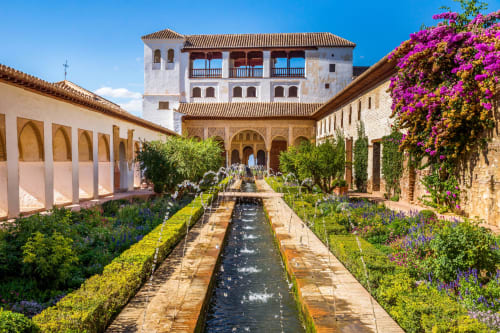 CTH Granada courtyard with water channel, flowering plants, and Moorish architecture in Armilla, Granada