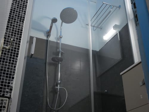 Modern shower enclosure with dual showerheads at Studio Face Marina apartment in Saint-François, Guadeloupe