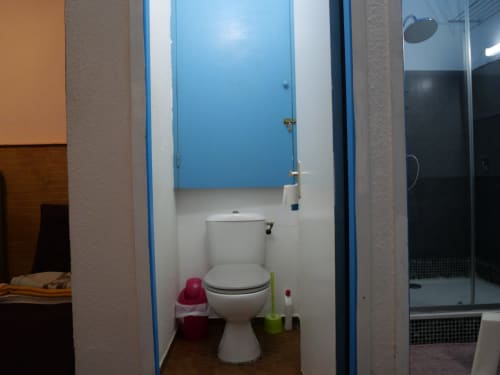 Shared toilet bathroom at Studio Face Marina apartment in Saint-François with blue accents and shower area