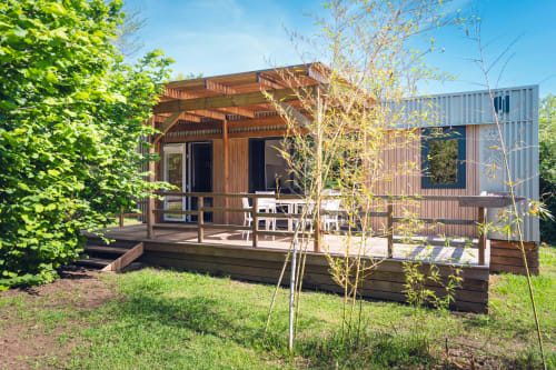 Mobil-home en bois moderne avec terrasse à Le Maquis Plage, Corse. Architecture contemporaine avec toit métallique et