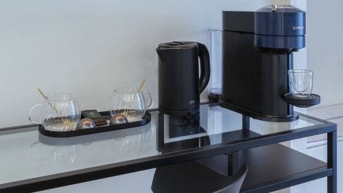 Modern coffee and kettle station with Nespresso machine at YOUnique Boutique Rooms Milano Urban Chic room