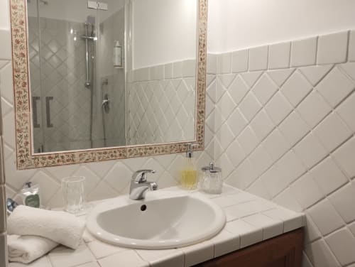 Bagno moderno con piastrelle subway bianche, lavabo rotondo e specchio decorativo in appartamento a Roma