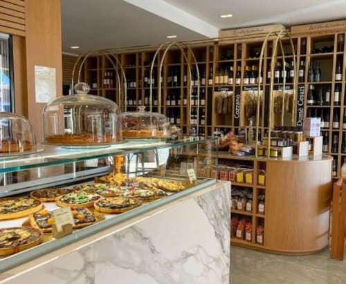 Alma Rossa bakery and wine shop in Lecci featuring display case with pastries and wine shelves