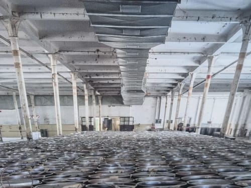 Spacious industrial warehouse with concrete pillars and metal ceiling beams at Villa Vista Lago di Como, Bellano