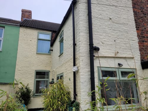 Cream-painted 2-bedroom villa at Jane's B&B in Guisborough with green accents and black downpipes