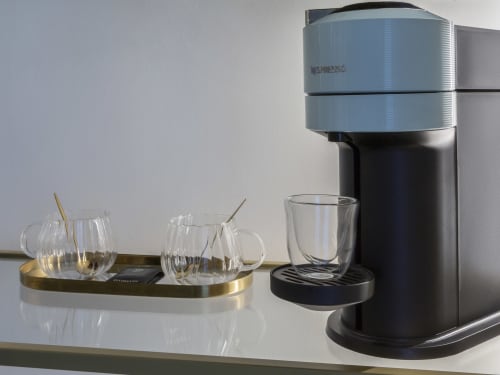 Nespresso Vertuo coffee machine with glasses on brass tray in YOUnique Milano romantic room