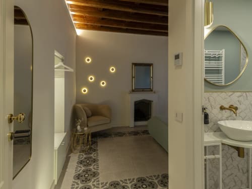 Elegant romantic room at YOUnique Boutique in Milano with fireplace, ambient lighting, and modern bathroom with vessel sink