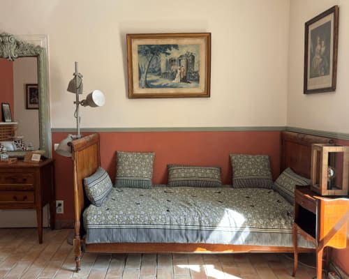 Period bedroom at Domaine Du Commandeur in Mondragon with antique bed, green patterned bedding, and classic furnishings