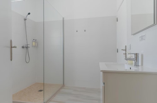 Banheiro moderno na Galagana Charm House com chuveiro walk-in, pia branca e design minimalista limpo em Golegã, Portugal