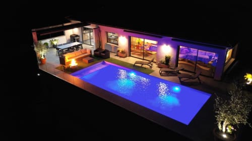 Corse et Zen luxury pool villa at night with illuminated blue swimming pool and modern terrace in Taglio Isolaccio