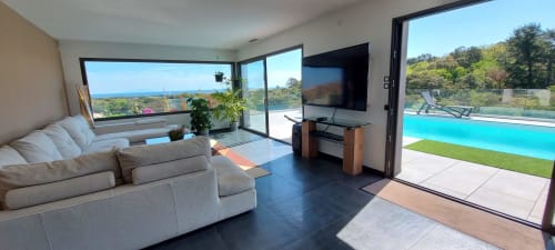 Modern living room with sea views, pool, and lounger at Corse et Zen, Taglio Isolaccio