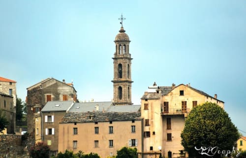 Charming Corsican village with church bell tower, stone buildings, and traditional architecture in Taglio Isolaccio