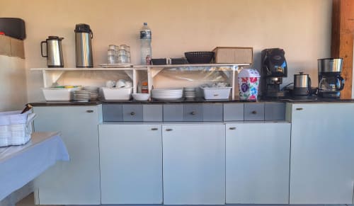 Cucina attrezzata presso il B&B Villa Matari a Fontane Bianche con scaffali, elettrodomestici e stoviglie