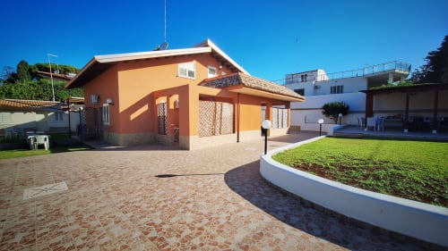 B&B Villa Matari a Fontane Bianche: casa arancione con patio, giardino curato, architettura moderna