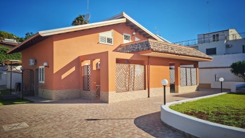 B&B Villa Matari a Fontane Bianche, Sicilia - casa in terracotta arancio con base in mattoni e corte paesaggistica