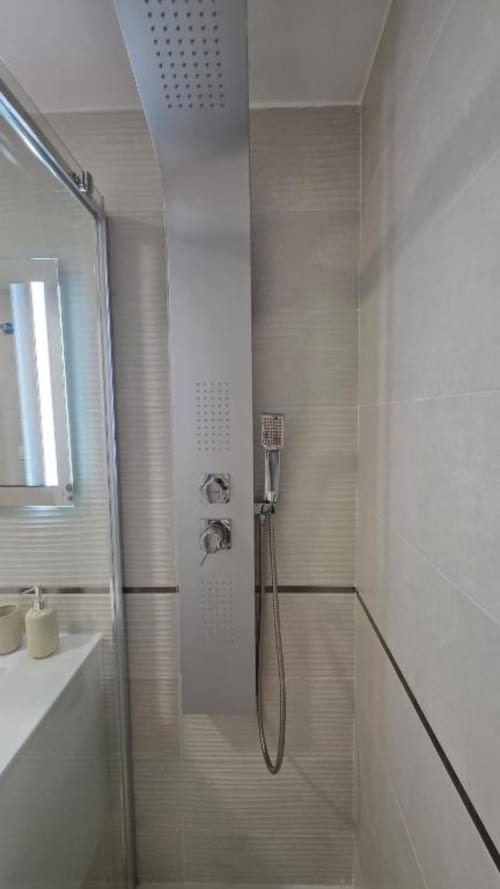 Moderna cabina de ducha con alcachofa de lluvia y ducha de mano en Apartment Daniel de MiramaRent, Benicàssim