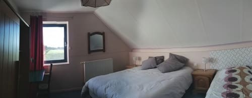 Cozy attic bedroom at Au Coeur des Champs with garden views, queen bed, and modern amenities