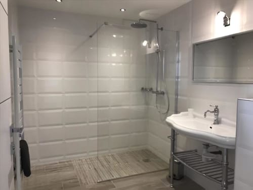 Modern bathroom in Sweet Holiday cottage, Porto-Vecchio, featuring walk-in shower with glass enclosure and white tile walls