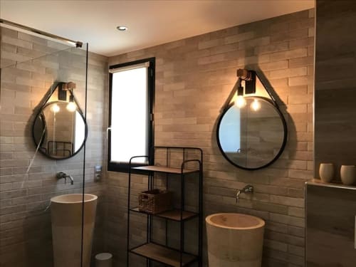 Modern bathroom with dual round mirrors, circular sinks, and brick walls at Sweet Holiday cottage in Porto-Vecchio