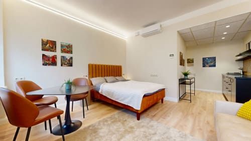 Spacious bedroom with queen bed & Urban Garden art by Maikro. Central Tartu apartment near Raekoja Square, RIMI & MyFitness. WiFi & AC