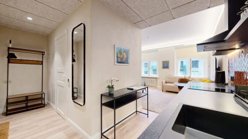 Modern kitchen with clothes rack, featuring Kairo's colorful artwork. Fully equipped in central Tartu near Raekoja Square, RIMI & MyFitness next door