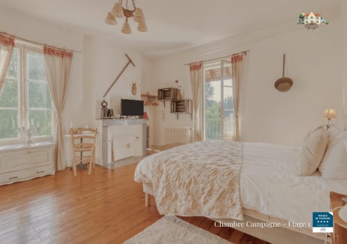 Spacious countryside bedroom at Baccara Lodge with wooden floors, twin beds, and rural views in Arengosse