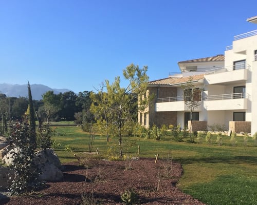 Sweet Holiday hotel in Porto-Vecchio with modern architecture, manicured gardens, and mountain views