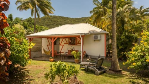 Le gîte Alpinia pour 4 à 6 personnes avec son jardin privatif, son salon détente en extérieur, ses transats, son hamac et barbecue pour des vacances tranquilles en Guadeloupe