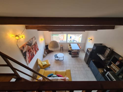 Overhead view of Mana Bleu apartment in Favone, showing yellow seating, terrace windows, and modern, managed by Corsu di Core