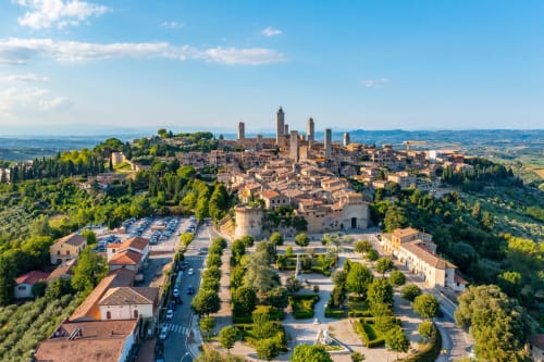 Aerial view of Montecatini Val di Cecina medieval town with towers and terracotta roofs surrounded by green Tuscan