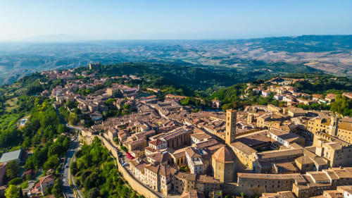 Aerial view of Montecatini Val di Cecina medieval town with terracotta roofs and Tuscan countryside