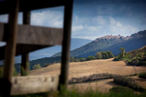 View of Montecatini Val di Cecina hillside village through window at I Castagnini B&B, Tuscany