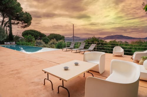 Sunset view from Case Zucco terrace in Terrasini, Italy with infinity pool, lounge seating and coastal landscape