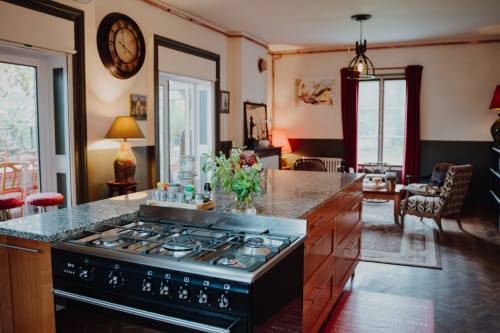 Modern kitchen and living area at Baccara Lodge, a luxury B&B in Arengosse, France with gas cooktop and elegant furnishings